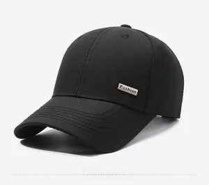 Detail of black cotton baseball cap with silver metal Fashion logo and stitch lines