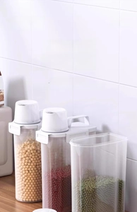 Detailed view of airtight cereal storage containers with measuring cups for grains