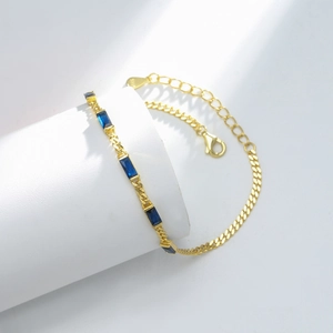 Detail of S925 sterling silver gold bracelet with blue rectangular gemstones and lobster clasp