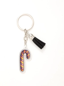 Detail of Halloween acrylic candy cane keychain with purple orange stripes and black tassel