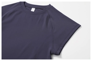 Detailed view of dark purple athletic t-shirt featuring ergonomic raglan sleeves and stitching