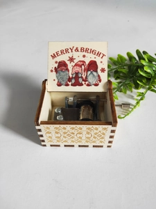 Detailed view of hand-cranked wooden music box with Merry & Bright interior Christmas print