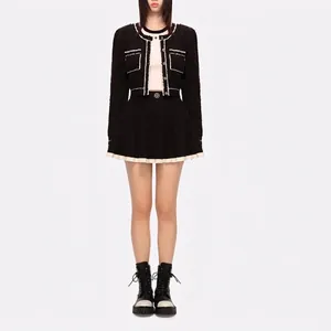 Contrast tweed jacket and pleated mini skirt set with white trim and metal buttons