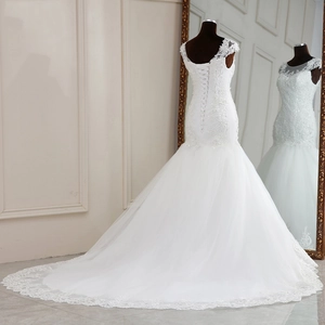 Elegant white mermaid wedding dress with lace floral appliques and a long cathedral train