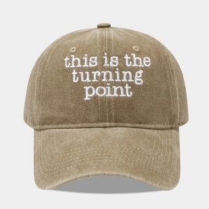 Close-up of white 3D embroidery on a khaki washed cotton baseball cap with letter detail