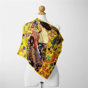 Détail d'un foulard en soie artistique doré avec motif de peinture sur un mannequin