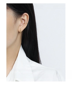Close-up of minimalist S925 sterling silver gold-plated ear cuff and hoop earring set