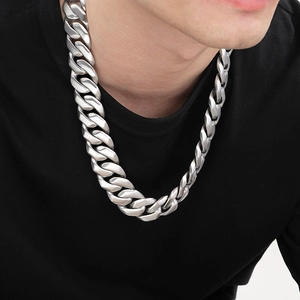 Detail of 24mm silver Cuban link chain necklace for men in polished stainless steel