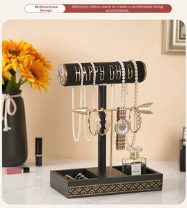 Three-tier jewelry stand with gold arrow bar and black matte base for rings and bracelets