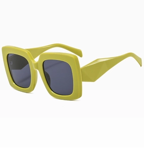Detail of lime green thick frame sunglasses with geometric temples and dark lenses