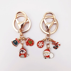 Detail of creative Christmas keychain with cartoon Santa Claus and tree alloy charms