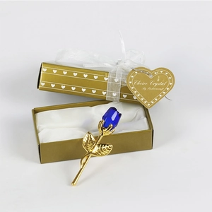 Blue crystal metal rose in a gold gift box with a white ribbon and heart-shaped tag