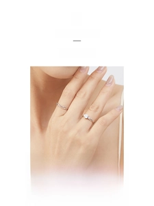 Detail of S925 sterling silver Mobius rings with sparkling zircon on a female hand