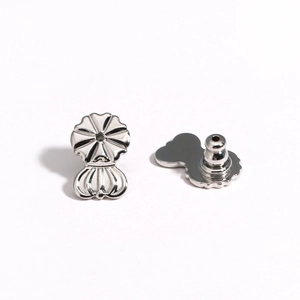 Detailed view of silver metal earring lifters with petal design for support