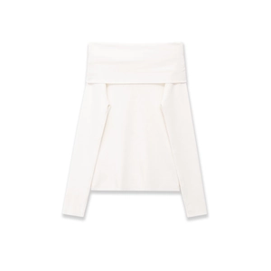 Detail of white off-shoulder top showing soft knitted texture and wide fold-over collar
