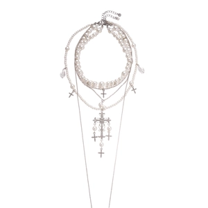 Elegant multi-layered pearl necklace with silver cross pendant on a white background
