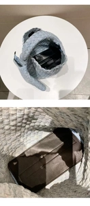 Macro view showing the woven denim texture and knotted handle detail of the tote bag