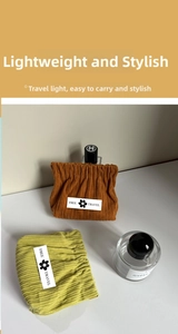 Detail of corduroy cosmetic pouches with elastic closure and travel logo label