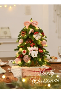 Close-up of mini Nordic Christmas tree with pink plush bears and warm LED string lights