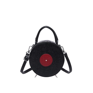 Vintage record style round handbag in black leather with red center and embossed patterns