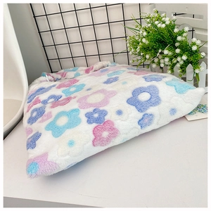 Detailed close-up of soft plush fabric texture with pink and blue floral patterns on a bag