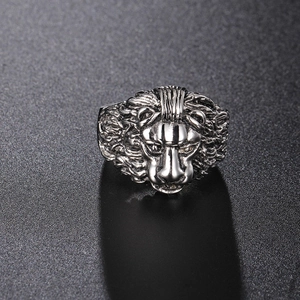 Detailed macro view of silver lion head embossed relief on heavy stainless steel ring