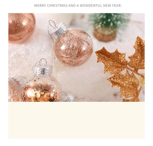 Macro shot of clear Christmas balls filled with rose gold wire and gold sequins