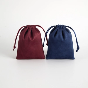 Detail of burgundy and dark blue suede drawstring pouches for jewelry and gifts