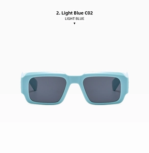 Detail of light blue oversized rectangular sunglasses with dark grey protective lenses