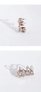 Macro shot of silver plated ear cuff featuring three square champagne cubic zirconia stones