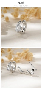 Detailed view of silver hoop earrings featuring pear-cut cubic zirconia in a minimalist style