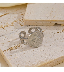 Macro shot of silver curb chain ring with embossed star and frosted texture