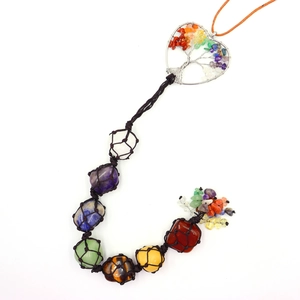 Close-up of seven chakra natural stones woven in a Tree of Life heart hanging ornament