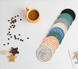 Top view of round silicone coasters in multiple colors with non-slip grooved texture