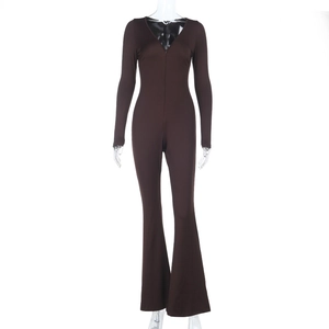 Detail of dark brown long-sleeve jumpsuit featuring deep V-neck zipper and flared hem