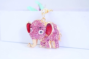 Detail shot of a pink rhinestone elephant keychain with red enamel and gold-tone finish
