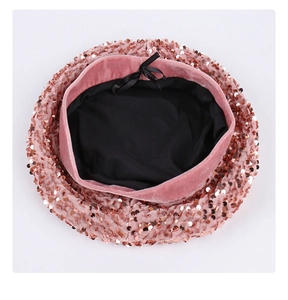 Top view of pink sequin beret hat with black lining and a cute bow tie detail