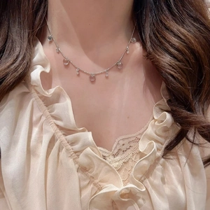 Elegant silver heart necklace with icy clear water-drop pendants on a minimalist chain