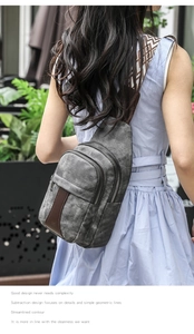 Detail view of grey canvas crossbody bag with decorative leather strap and geometric patterns