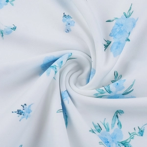 Detailed close-up of blue floral textile showing soft fabric texture and drape