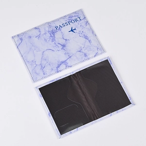 Macro detail of marble pattern passport holder showing interior slots and cover