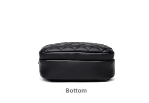 Detailed bottom view of a black quilted leather crossbody bag with neat stitching