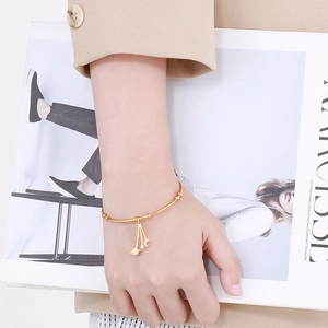 Gold star and moon charm bracelet for women in polished stainless steel with planet dangles