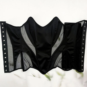 Detailed flat lay of black corset top featuring satin mesh patchwork and metal eyelets