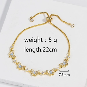 Detailed view of adjustable gold butterfly bracelet with blue opal and zircon stones