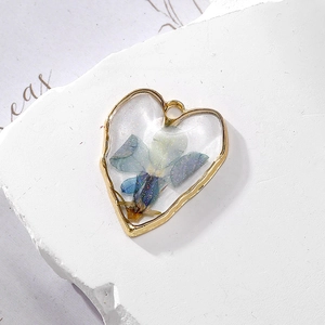 Golden heart pendant with blue dried flowers and glitter in transparent resin