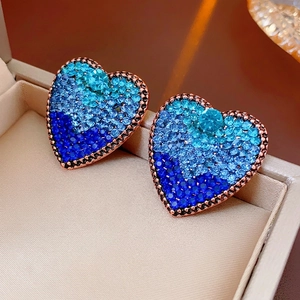 Vintage heart earrings in rose gold with blue gradient crystals on beige gift box