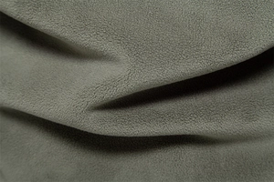 Macro shot of high-density grey-green polar fleece fabric with soft texture