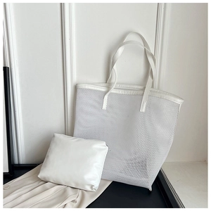 Detailed view of white mesh beach tote bag with a matching leather inner pouch