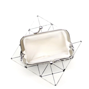 Top view of opened animal print coin purse with white fabric lining and silver metal clasp
